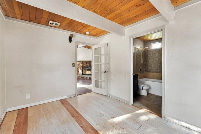 interior space with beam ceiling, french doors, wood ceiling, and light wood-type flooring