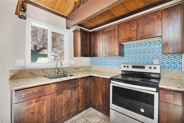 kitchen with decorative backsplash, light stone counters, sink, beam ceiling, and stainless steel range with electric cooktop