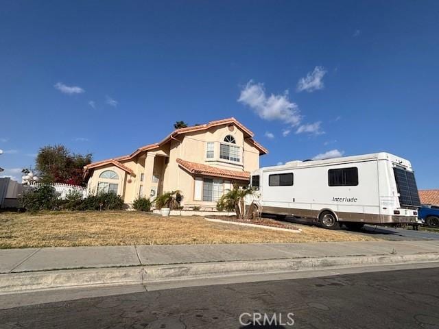 view of front of home with a tiled roof and stucco siding