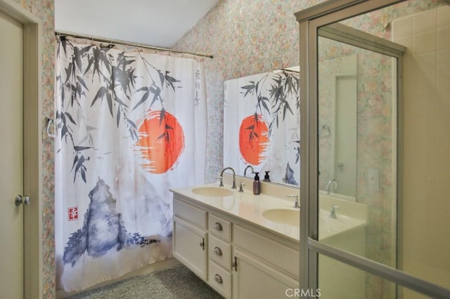 full bath featuring double vanity, shower / bathtub combination with curtain, a sink, and wallpapered walls