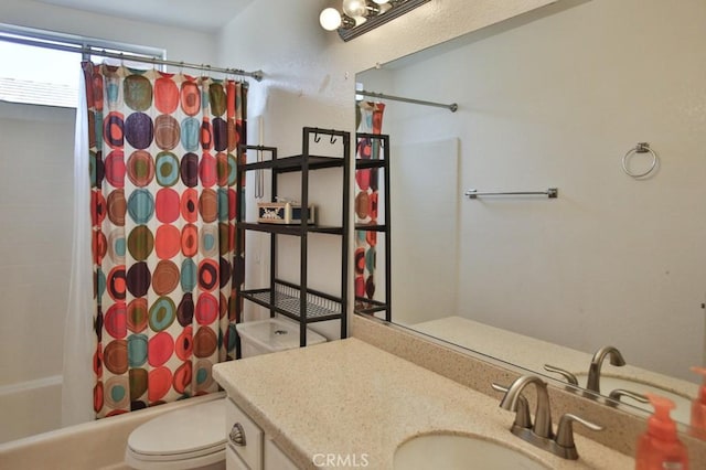 full bathroom featuring toilet, shower / bath combination with curtain, and vanity