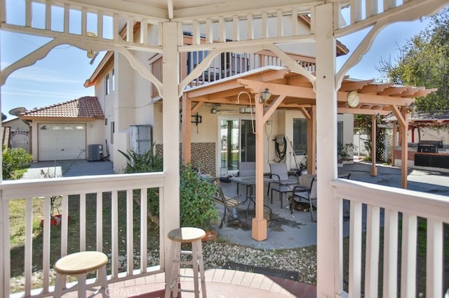 view of patio / terrace featuring a garage and central AC