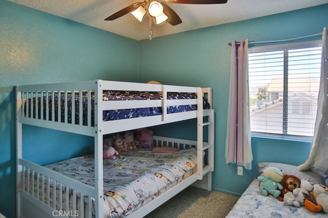 bedroom featuring multiple windows, a ceiling fan, and carpet flooring