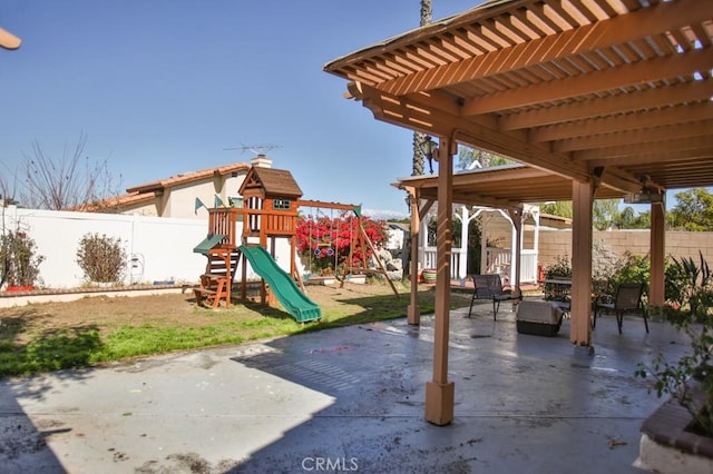 view of playground featuring a fenced backyard and a patio