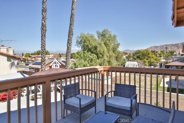 deck with a residential view and a mountain view