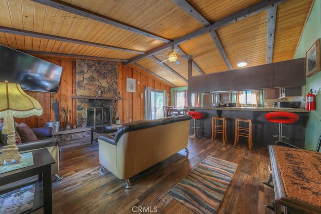 living room featuring ceiling fan, vaulted ceiling with beams, dark hardwood / wood-style floors, and wooden walls