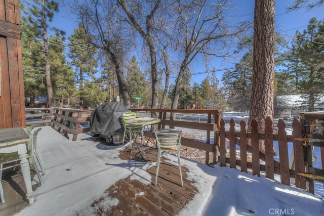 snow covered deck featuring area for grilling