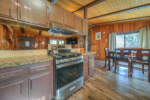 kitchen with wood walls, gas stove, range hood, light wood-type flooring, and wood ceiling