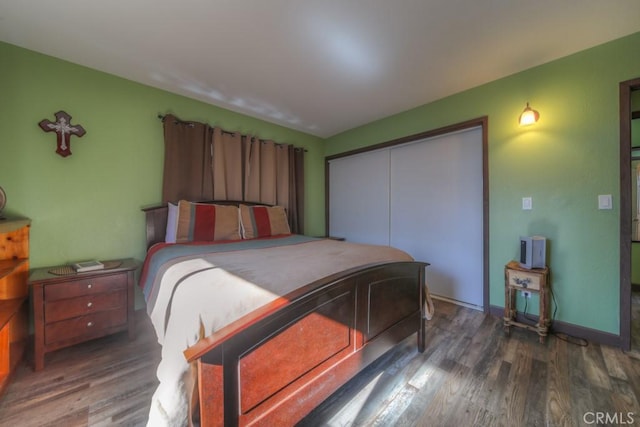 bedroom featuring dark wood-type flooring and a closet