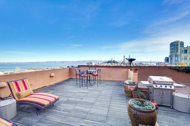 view of patio / terrace featuring a grill and a water view