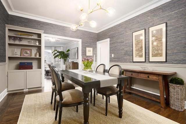 dining room with a chandelier, crown molding, and dark hardwood / wood-style floors