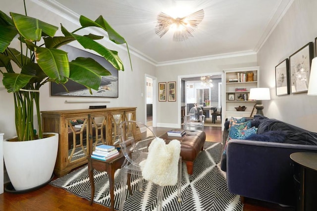 living room featuring ornamental molding, wood-type flooring, and built in shelves