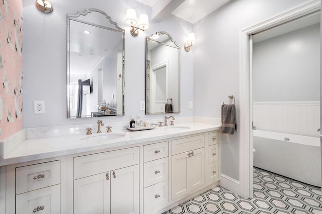 bathroom featuring tile patterned floors, a bath, and vanity