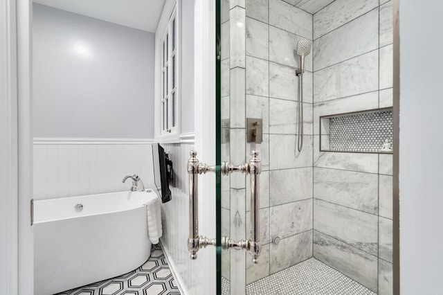 bathroom featuring shower with separate bathtub