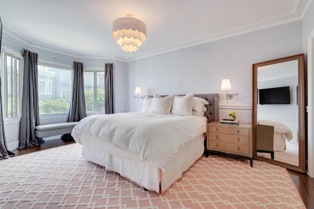 bedroom with ornamental molding and light wood-type flooring