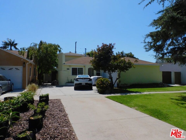 view of front of property with a garage and a front lawn