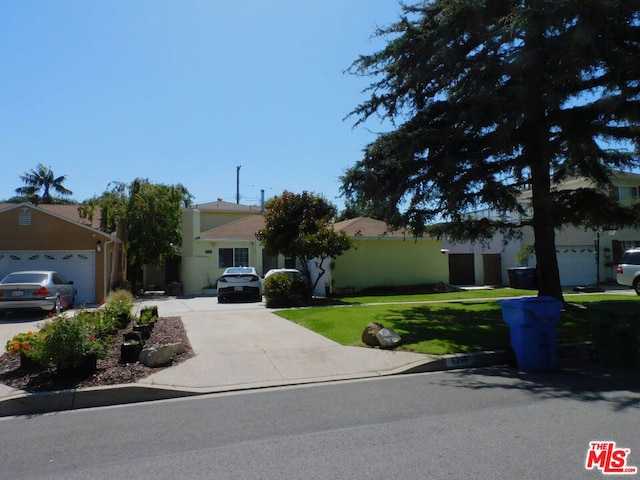 ranch-style home with a garage and a front yard