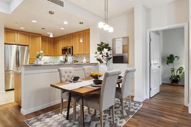 dining room with light hardwood / wood-style flooring