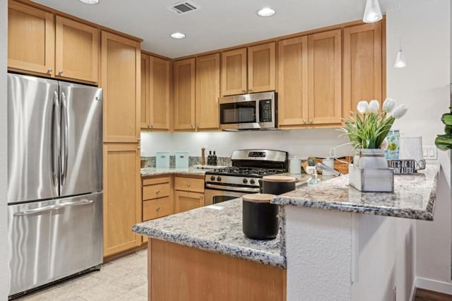 kitchen with stainless steel appliances, light stone countertops, and kitchen peninsula