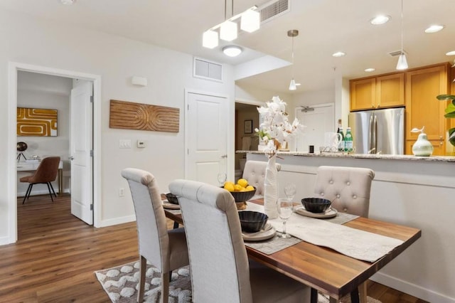 dining area with dark hardwood / wood-style flooring