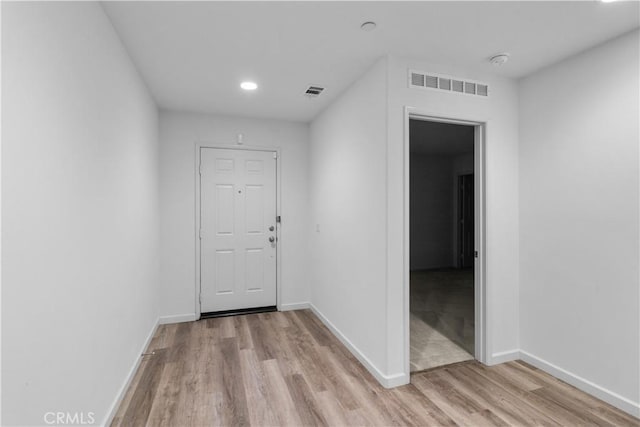 corridor with light wood-type flooring