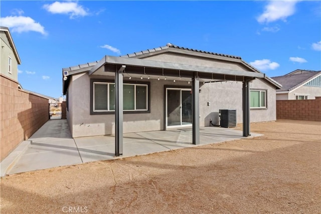 rear view of house with a patio area and central air condition unit