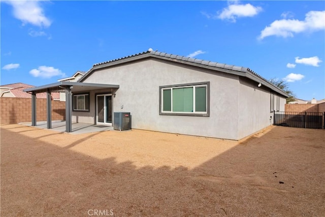 back of house with central AC unit and a patio area