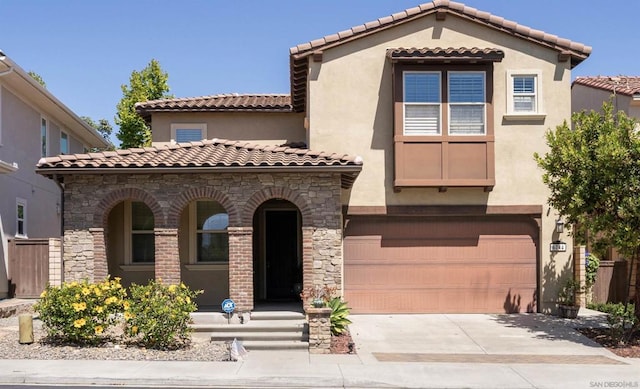 mediterranean / spanish home with a garage