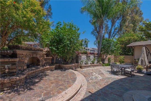 view of patio featuring an outdoor stone fireplace