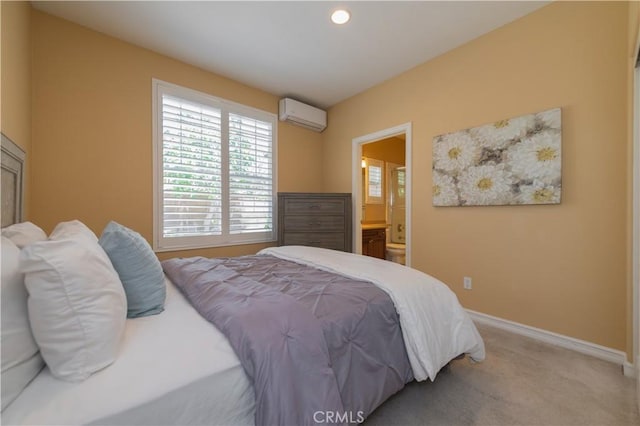 bedroom with light carpet, ensuite bath, and a wall mounted AC