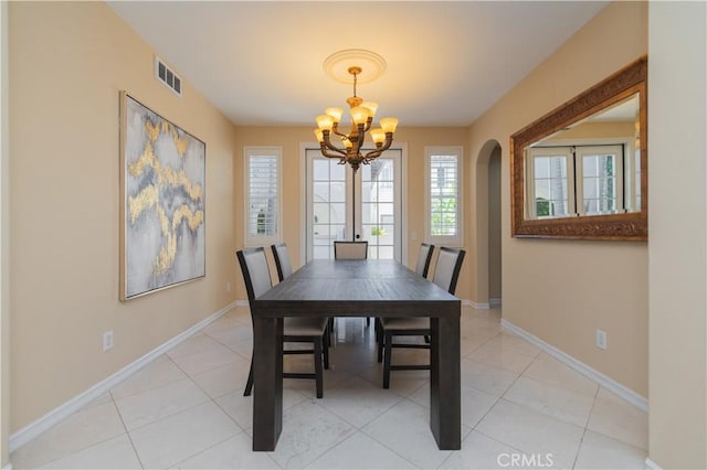 dining room featuring an inviting chandelier and light tile patterned floors