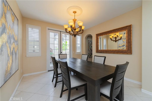 tiled dining room featuring french doors and a notable chandelier