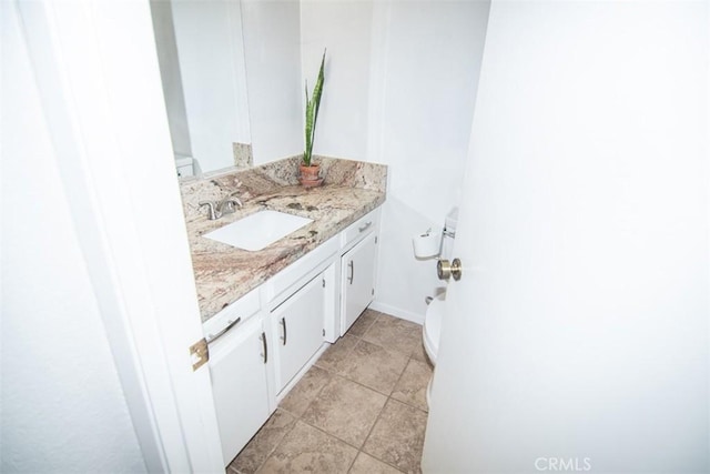 bathroom with toilet and vanity