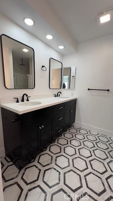 bathroom with a shower and vanity