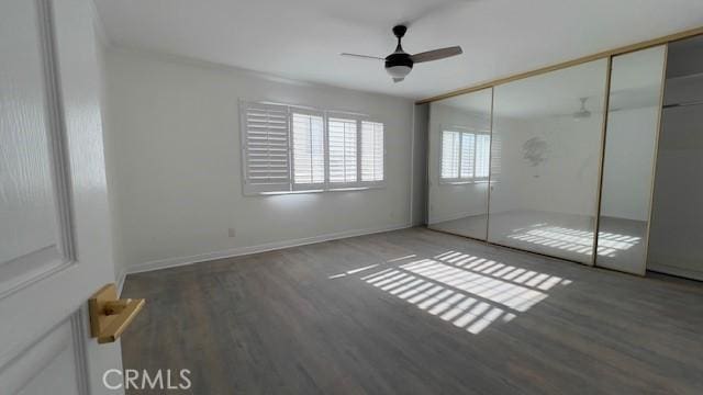 unfurnished bedroom featuring ceiling fan, hardwood / wood-style floors, and a closet