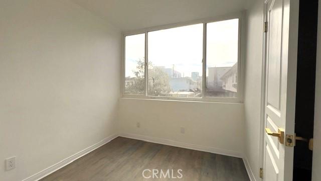 empty room featuring dark wood-type flooring