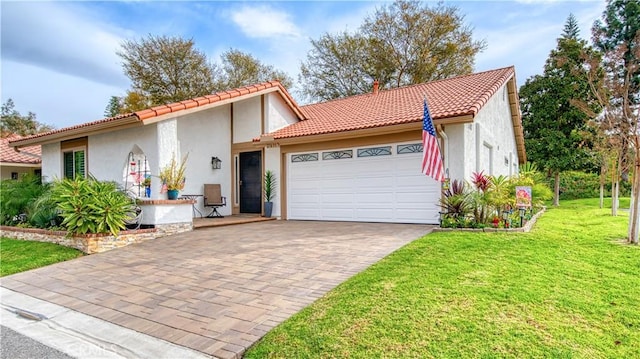 mediterranean / spanish house with a garage and a front lawn