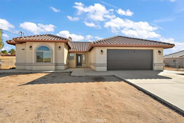 mediterranean / spanish house featuring a garage