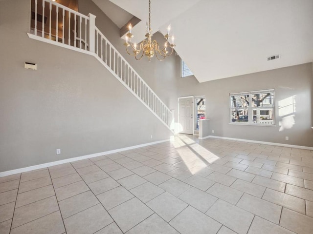 unfurnished living room with light tile patterned floors, a chandelier, and high vaulted ceiling