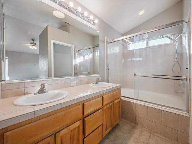 bathroom featuring shower / bath combination with glass door, lofted ceiling, vanity, tasteful backsplash, and ceiling fan