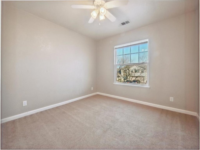 carpeted empty room featuring ceiling fan