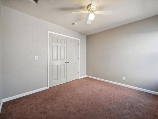 unfurnished bedroom with ceiling fan, a closet, and carpet flooring