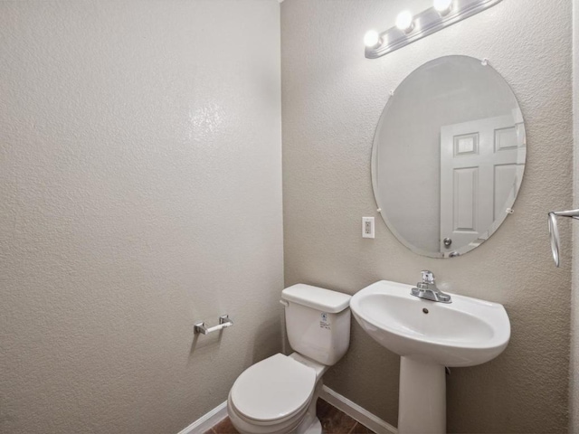 bathroom with toilet and sink