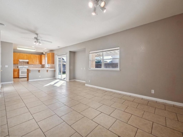 unfurnished living room with ceiling fan and light tile patterned floors