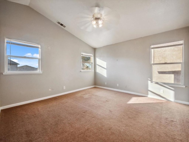 empty room with ceiling fan, carpet floors, and vaulted ceiling