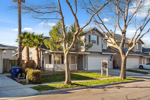 view of front of home featuring a front yard, covered porch, and a garage