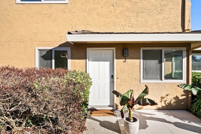 property entrance featuring a patio area