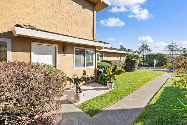 entrance to property featuring a yard