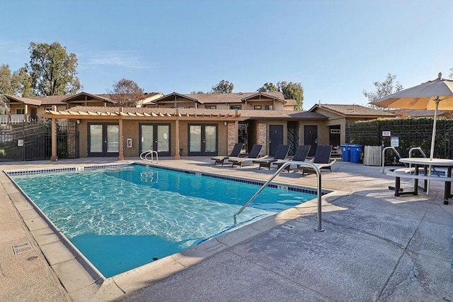 view of pool featuring french doors and a patio