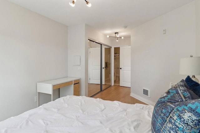 bedroom featuring light wood-type flooring and a closet